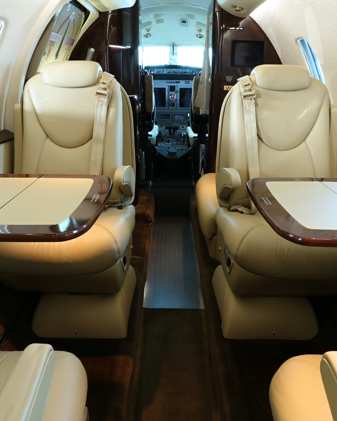 Interior aircraft cleaning - private jet cabin with tables and cockpit view